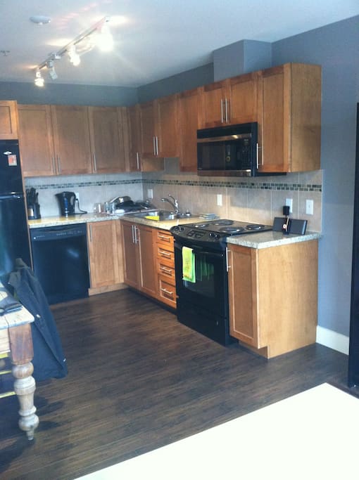 Fully equipped kitchen with fridge, microwave, dishwasher, coffee machine and all crockery.