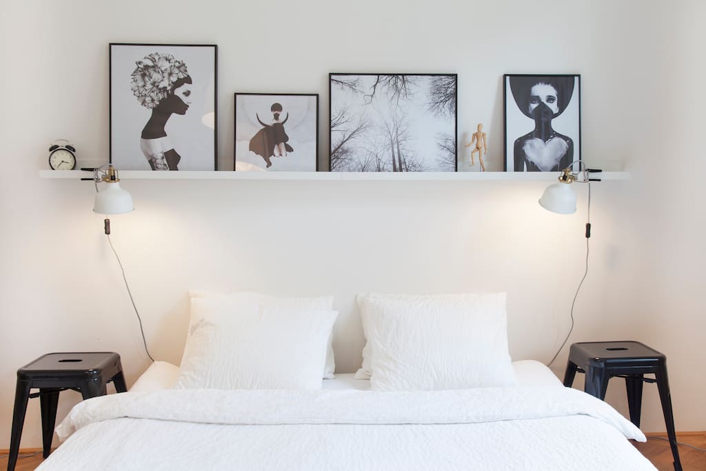 Cozy stylish bedroom with (what else) pictures and reading lamps ;)