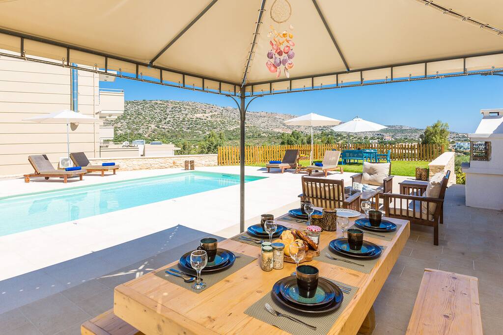 Dining area next to the pool, under a tent
