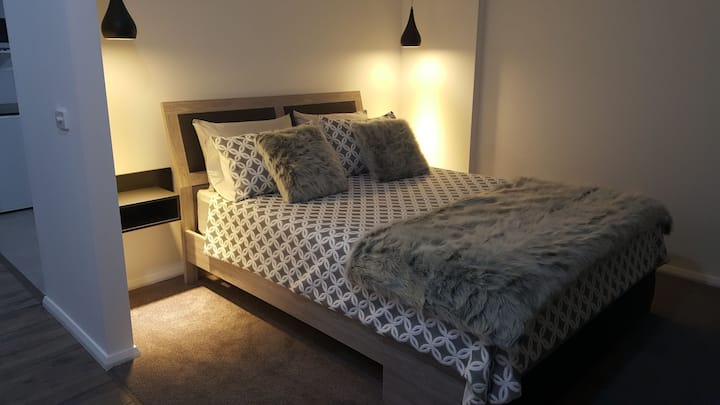 The comfy queen bed with quality linen and bedding.