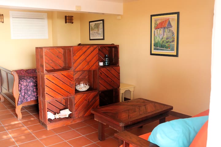 A view to the seating area with the bed set behind a one of our pieces of homemade furniture.