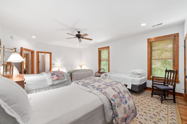 Upstairs bedroom #1 - two twin beds, one extra long twin bed, and a queen bed