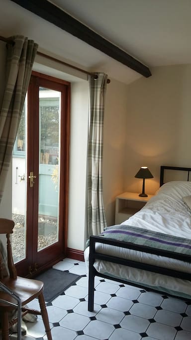 Double doors leading to back garden with view to farm and surrounding countryside.