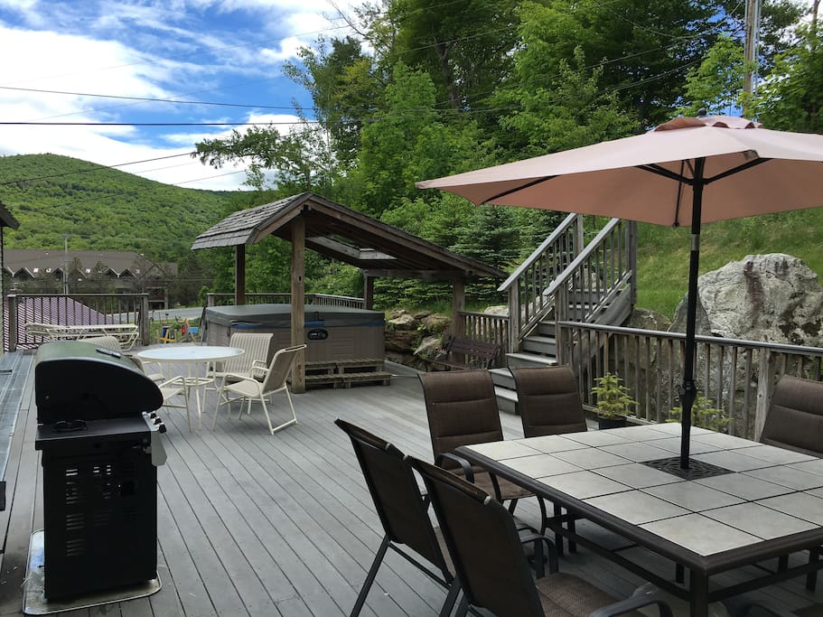 Our oversized back deck w/ hot tub, grill, and patio seating