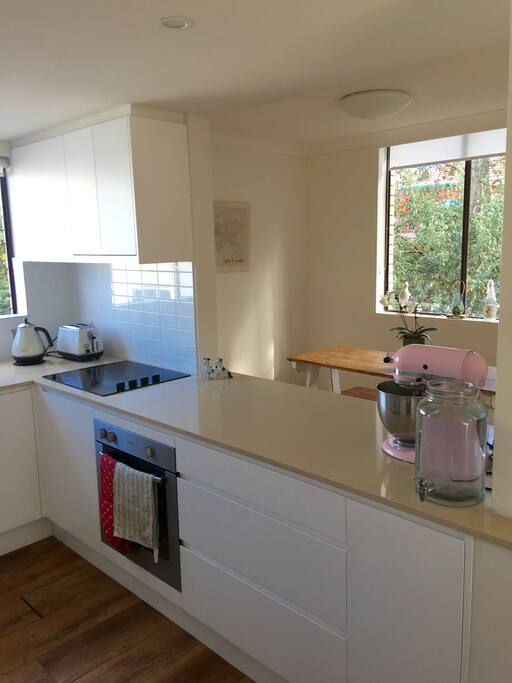 Full kitchen with electric oven/stove top, kettle, toaster, fridge/freezer and washing machine.