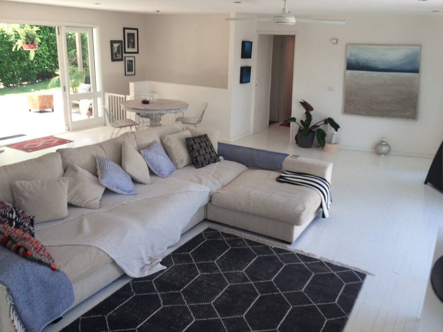 Living area flows out to back entertaining deck and upper level garden.