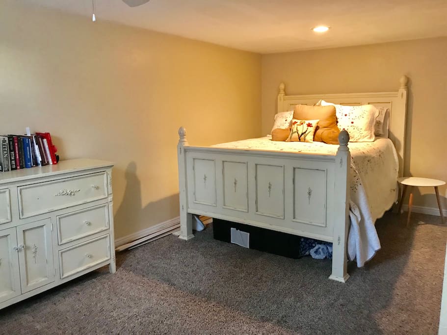 Large bedroom with two dressers, nightstand, full closet, and--most importantly--a queen sized bed.