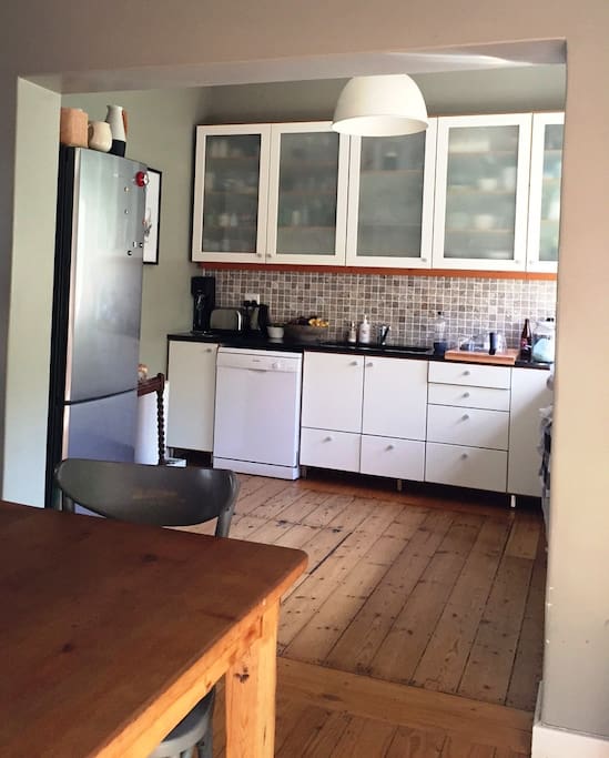 Multi-use kitchen leading into dining area.