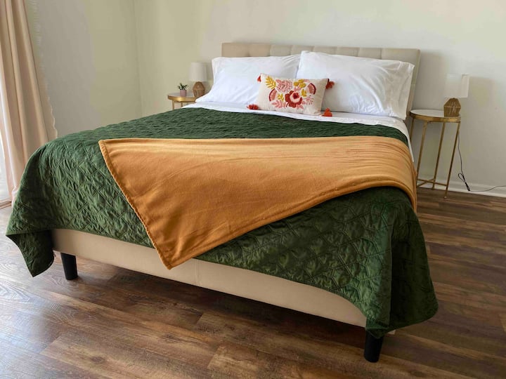 Relax in the charming second floor queen bedroom that overlooks the backyard.