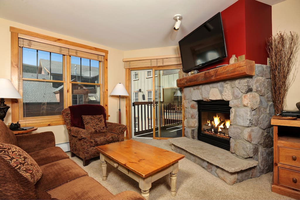 Relax in the luxurious living area, complete with natural stone gas fireplace