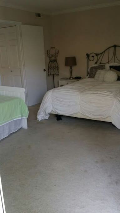 Bedroom with a queen size bed and a daybed, other room set up same way, queen and futon.