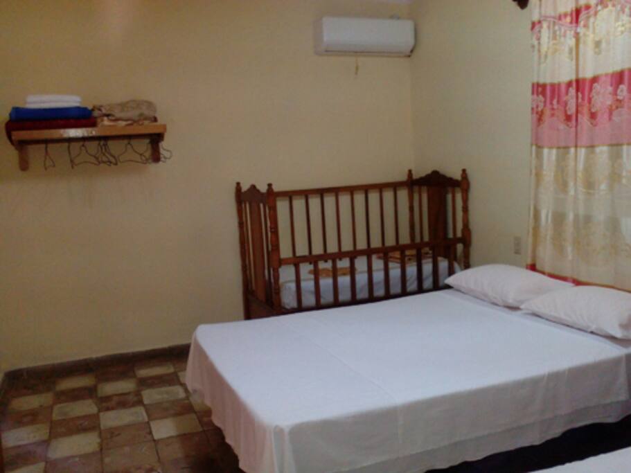 Habitación con cuna y aire acondicionado