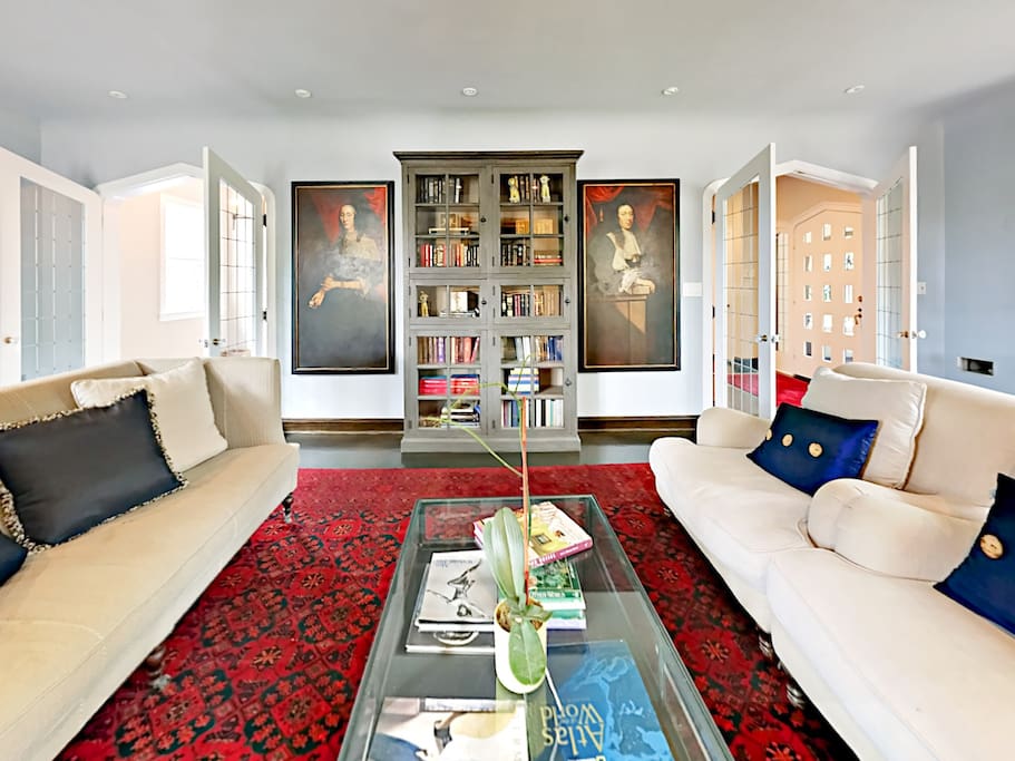 The sunlit living space has captivating artwork and fine furnishings.