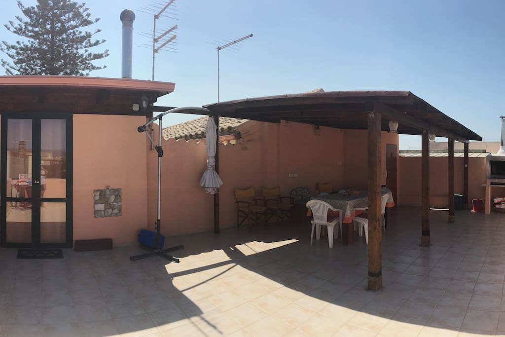 The Terrace with on the left the entrance door to the living room, view from the stairs