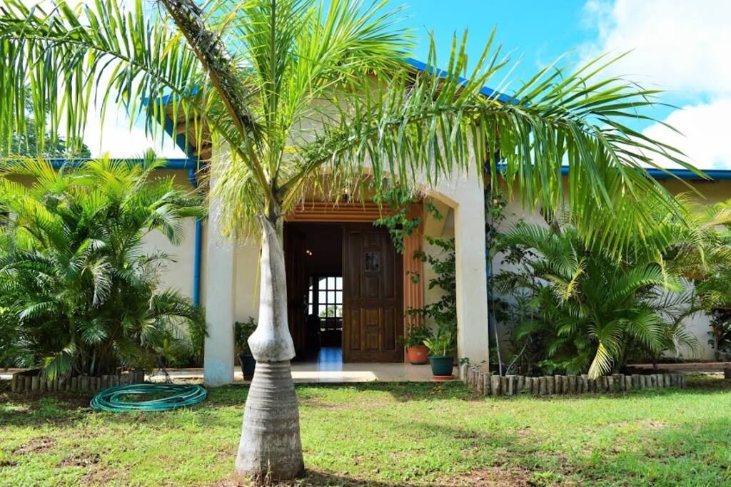 Arched, covered porch at front entrance from the garden area.