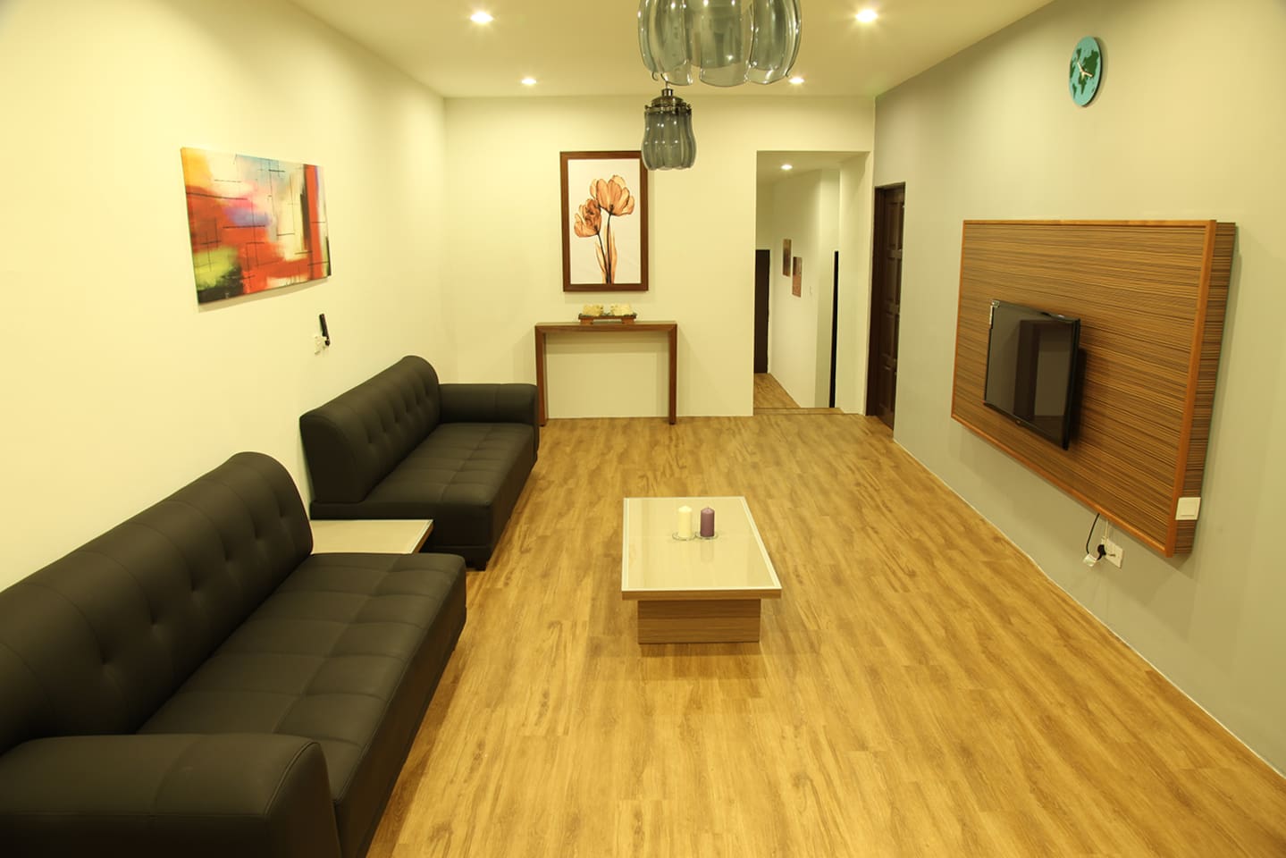 Living area with big couch and a LCD TV.