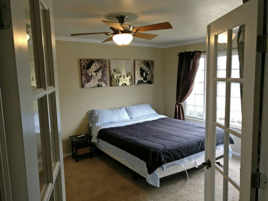 French room with French doors, includes Cali King sleep number bed, French chocolate, mini fridge, closet and big desk - working space, cielling fan, wifi