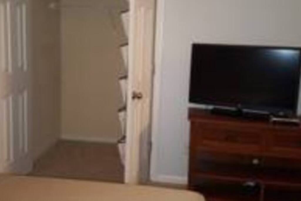 Closet, entertainment stand and tv