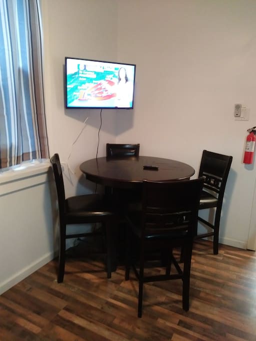 bar top table for television in eat in kitchen that is shared with one other room