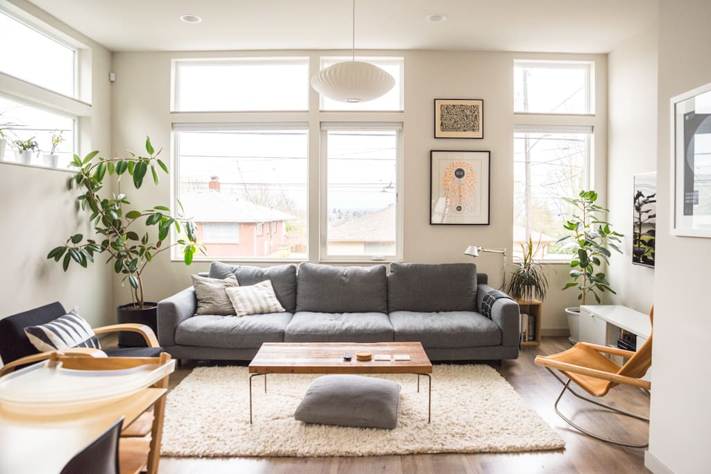 The main level with open floor plan with living room, dining room, kitchen, and powder room. It's a perfect chill out spot for fellow design enthusiasts and plant lovers.