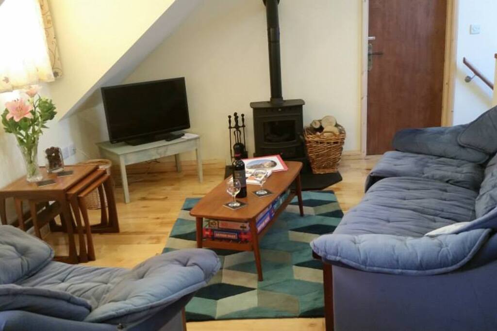 The first floor open plan lounge, with Villager wood burner