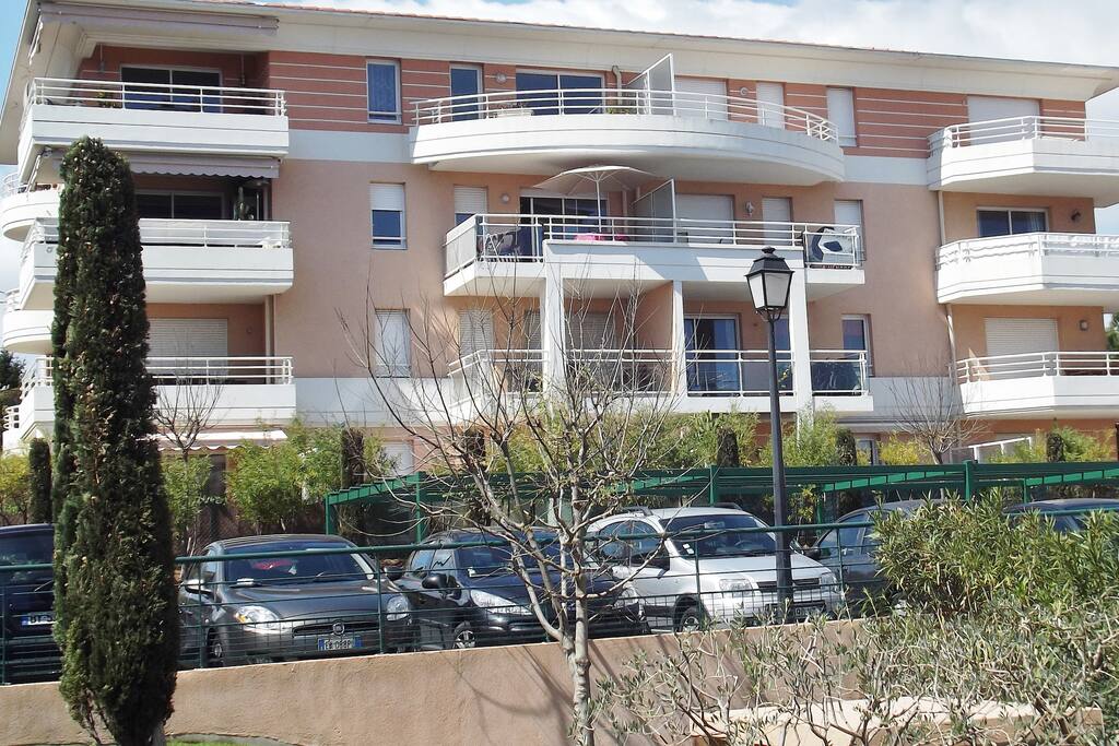 Secure modern apartment with lift, shown here with umbrella on balcony.