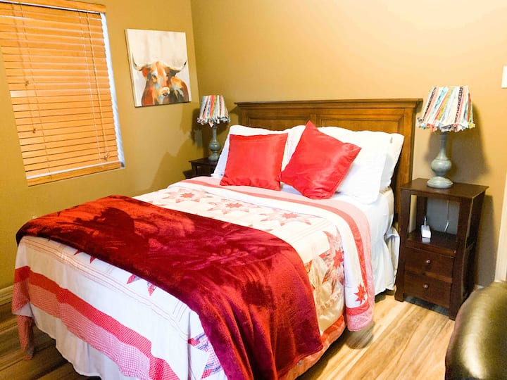Red is color for life, love, health and courage. This room made with red quilt on bed and all different colors in its lamps, sunlight coming in from 2 different window  gives you the feeling of warmth, love, health and happiness !