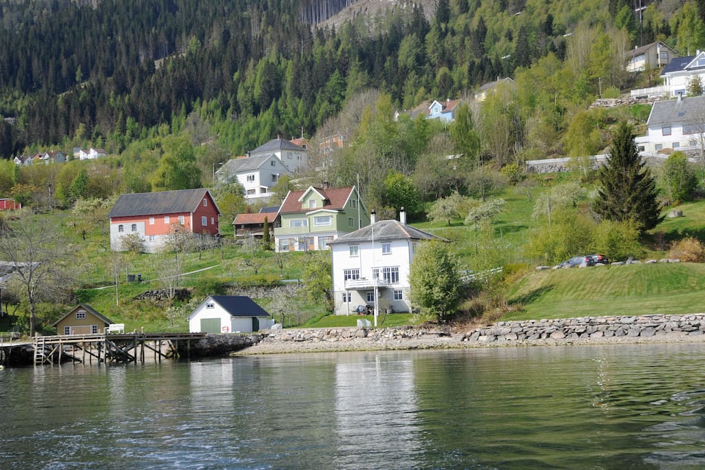 Leililegheiten ligg i kjellaren i det kvite huset ved fjorden.
