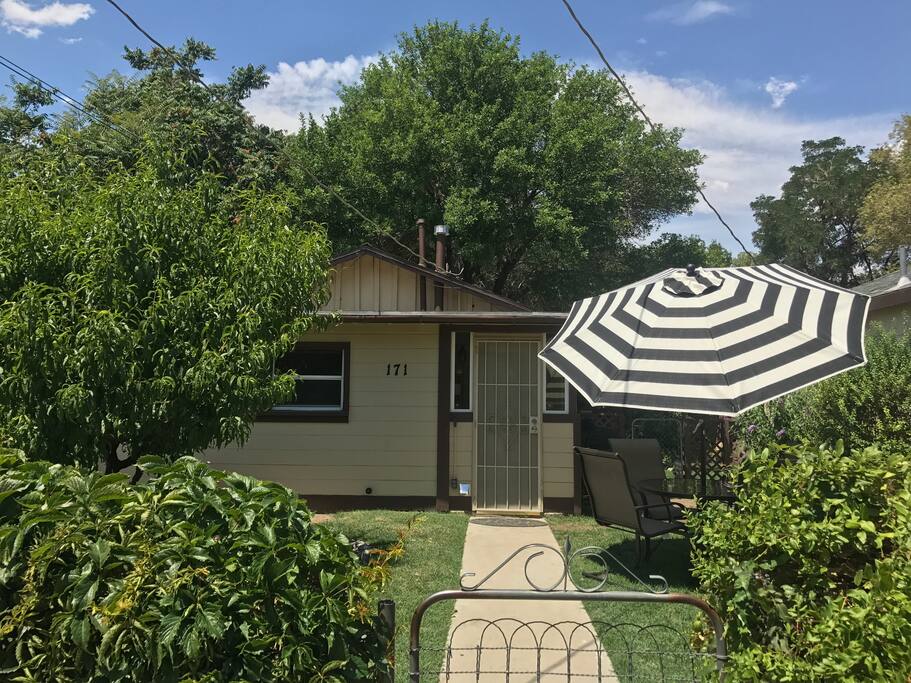 Front of house. Yard with creek and table n chairs great for outdoor dining