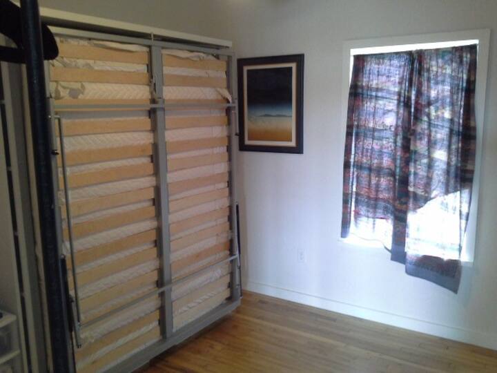 Guest Room: Bookcase/bed revolved around to expose wall bed