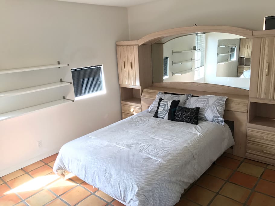 Bedroom, with queen-sized bed and plenty of natural light, and storage (full-length wardrobe just to the right of the bed, with hangers, a spare cover, and storage for clothes).
Also a full length mirror in front of the bed.