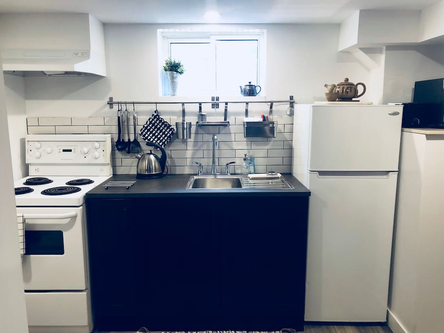 a full kitchen, with stove, fridge, microwave, toaster, and mixer! Just ready for you to make a home-cooked meal!
