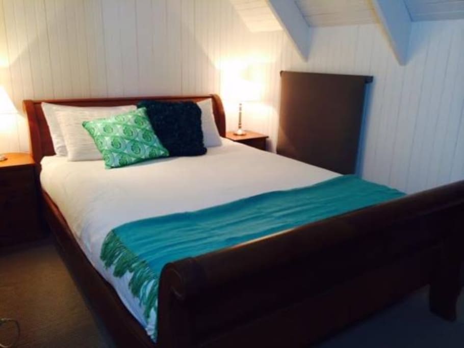 Queen-sized double bed, room has cathedral ceilings and exposed beams.