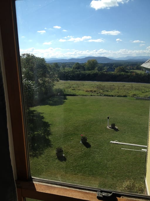 View from bedroom window. Lie in the new king size bed and view the mountains and a sliver of Lake Champlain.