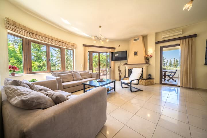 Elegant living & dining area with a cozy fireplace
