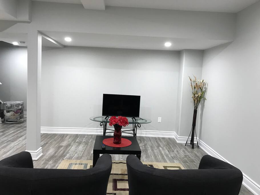 Living room with sofa chairs , dining table and tv