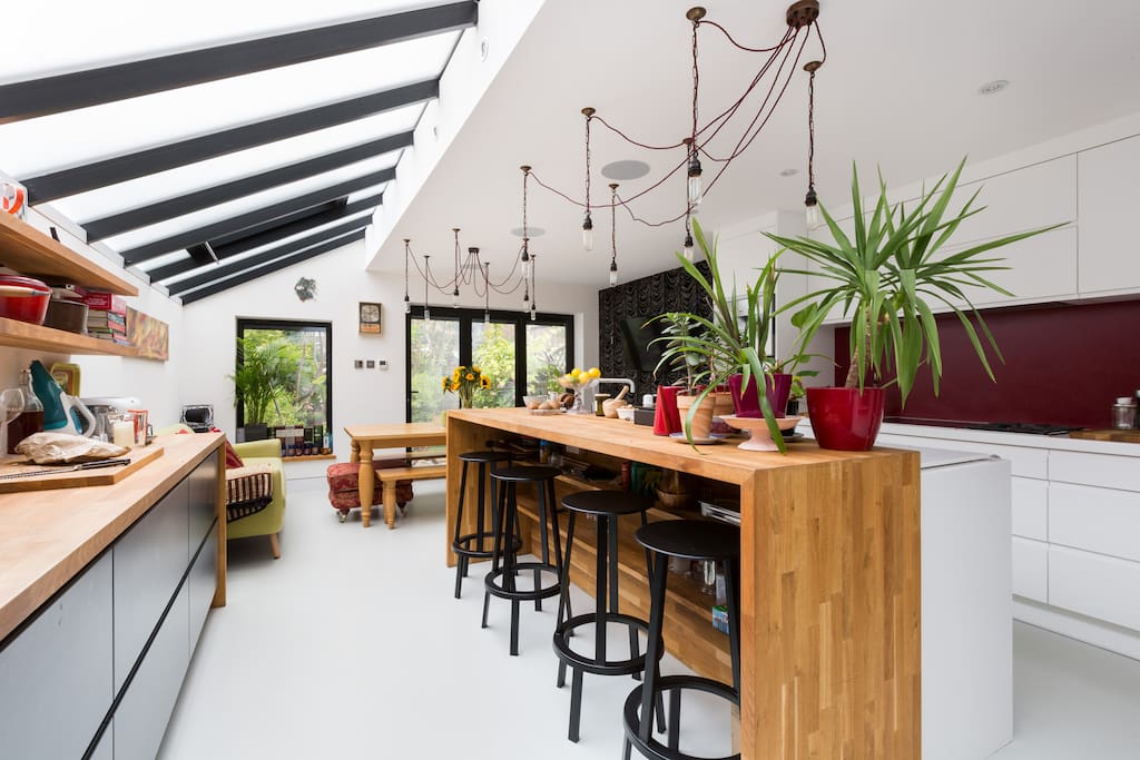 The oak breakfast bar in the stylish, modern open plan kitchen/dining room