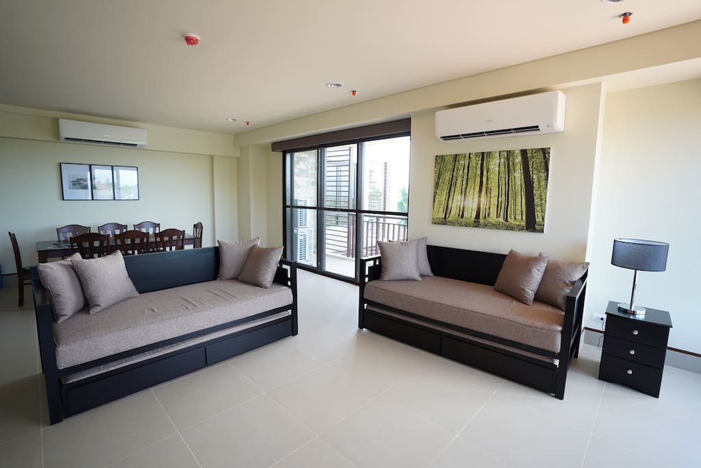 Living and dining area with sliding doors to balcony