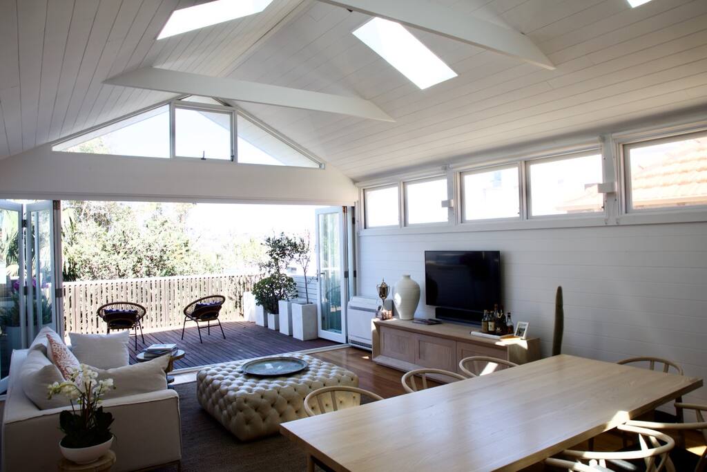 Upstairs open plan living / dining, featuring full kitchen with European appliances, designer furniture, built in gas BBQ and leafy views