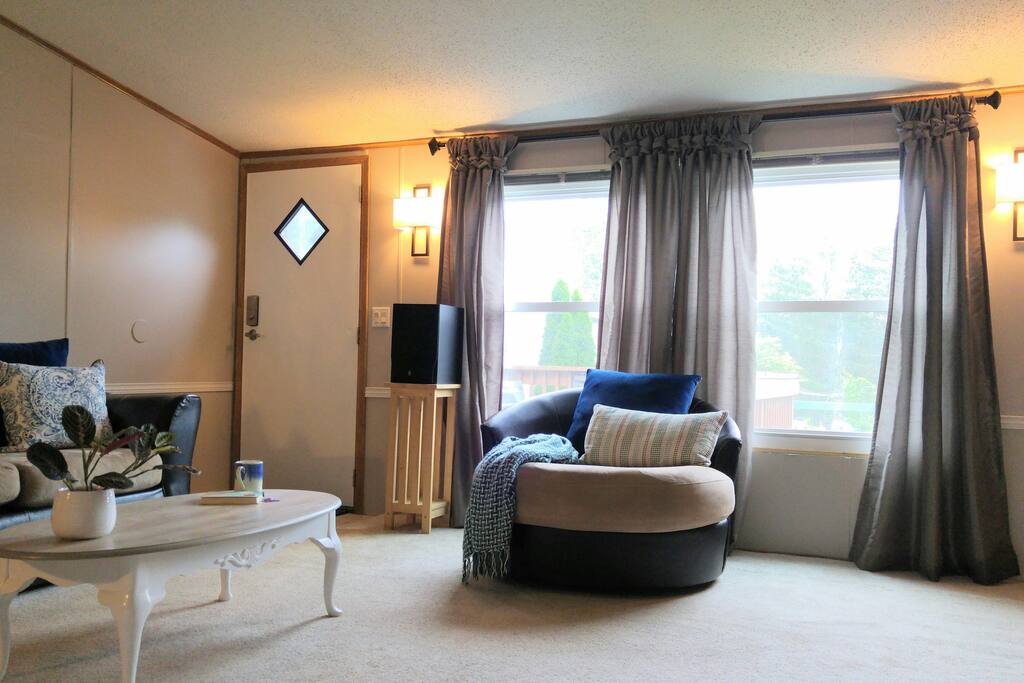 Very inviting living room with lots of light from huge windows.