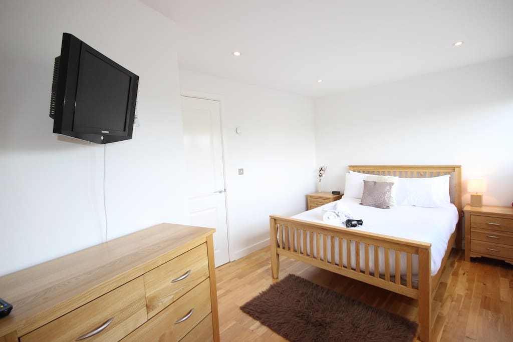 Comfortable bedroom with TV and storage