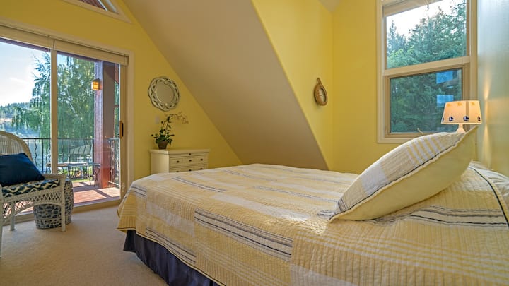 Guest room with access to balcony shared with other guest bedroom.  Bedroom has queen bed.
