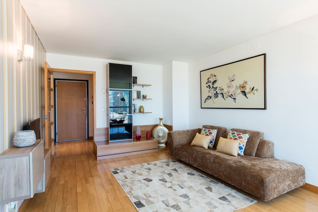 Living room with air conditioner and cable TV with 180 channels.