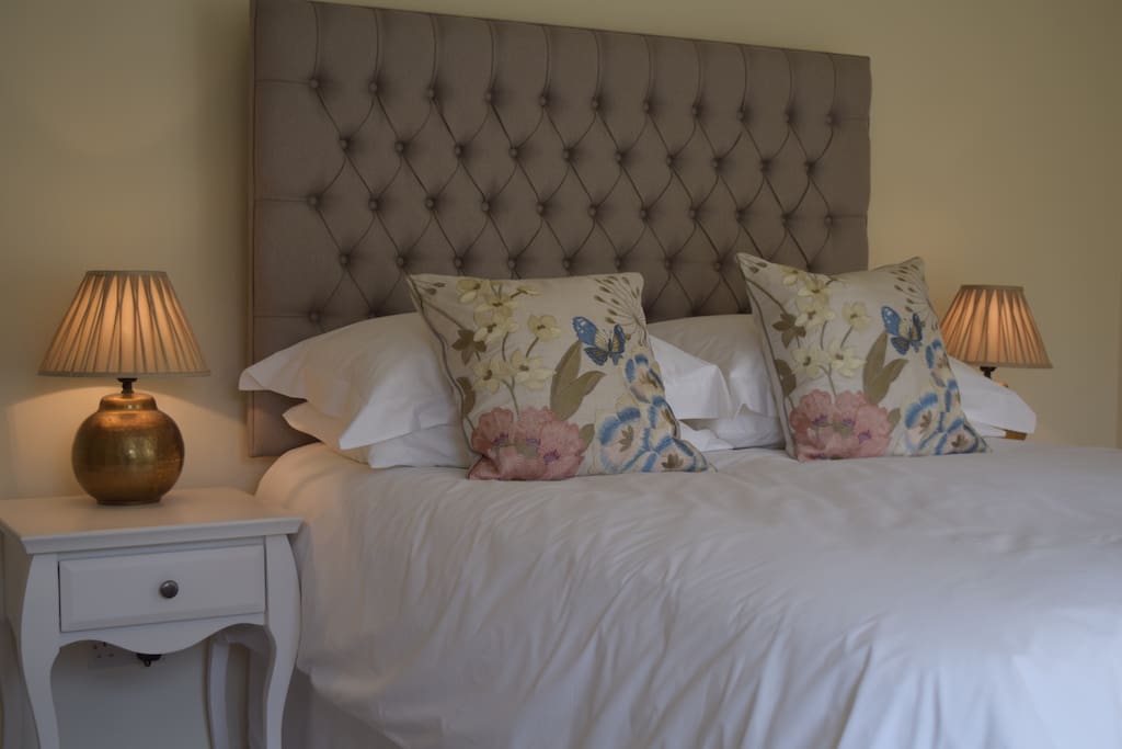 Master bedroom with kingsize bed and luxury bedding