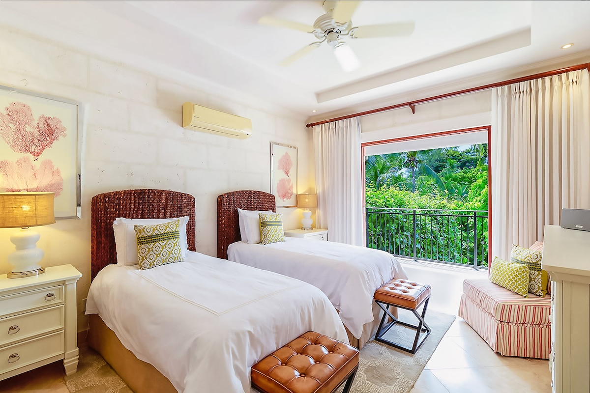 A beautiful bedroom with US king size bed, air conditioning, ceiling fan, security safe, walk in wardrobe, private balcony, Smart TV and an en suite.