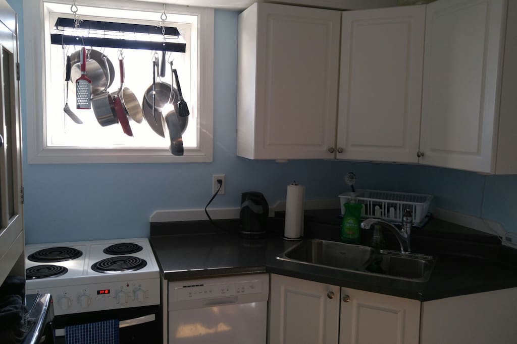 Fully equipped kitchen with stove, oven, dishwasher, fridge, microwave, small appliances