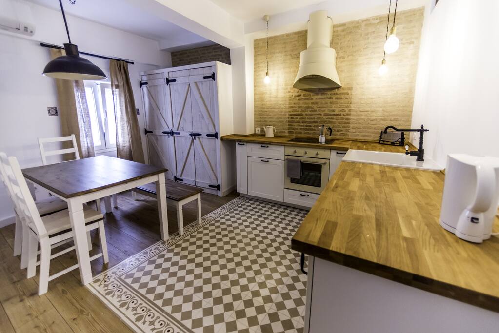 Kitchen with air conditioning and amenities like fridge, oven, glass-ceramic cooktop, microwave, washing machine, electric water kettle, toaster, etc.