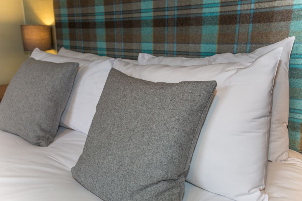 Bespoke headboards and complimentary soft furnishings give each room at Butt Lodge its own unique character