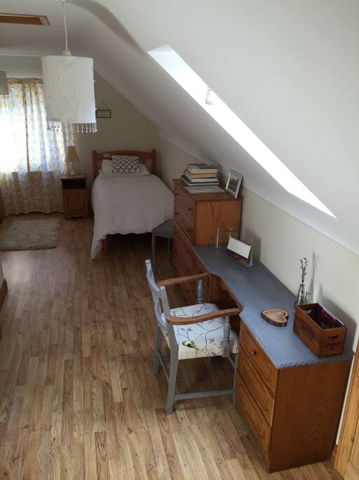 Door into room showing dressing table, draws and single bed