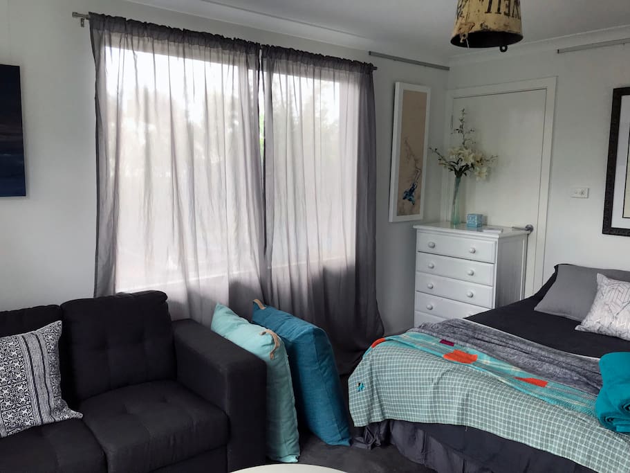 The main bedroom and living room filled and lit with lovely natural light.